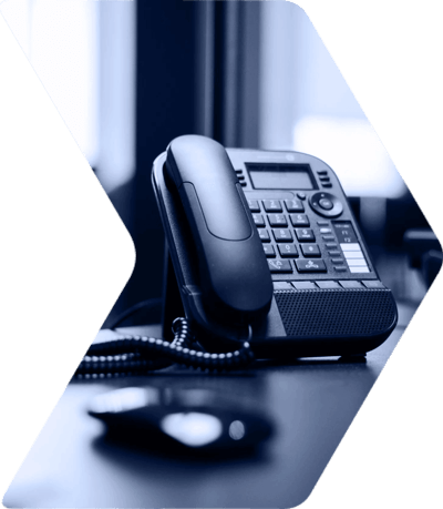 Office desk phone with coiled cord and blurred background, symbolizing business communication and professionalism